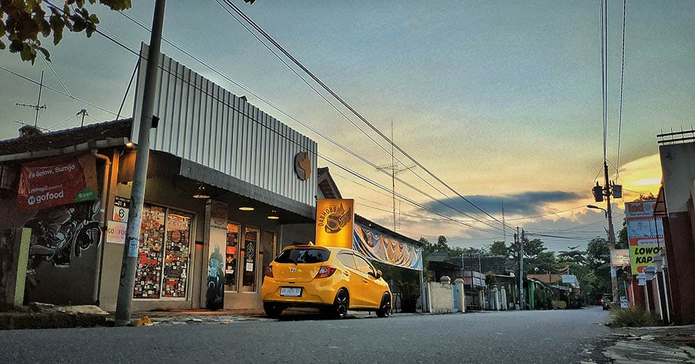 A person working on a motorcycle in a stylish workshop.